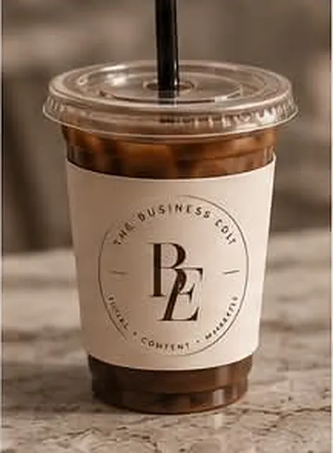 Iced coffee in a cup sleeve printed with the BE monogram